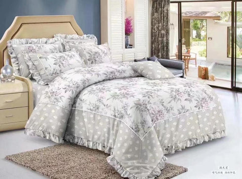 A six piece comforter set with a floral pattern displayed on a double bed, including a comforter, bedsheets, pillow covers, and cushion covers.